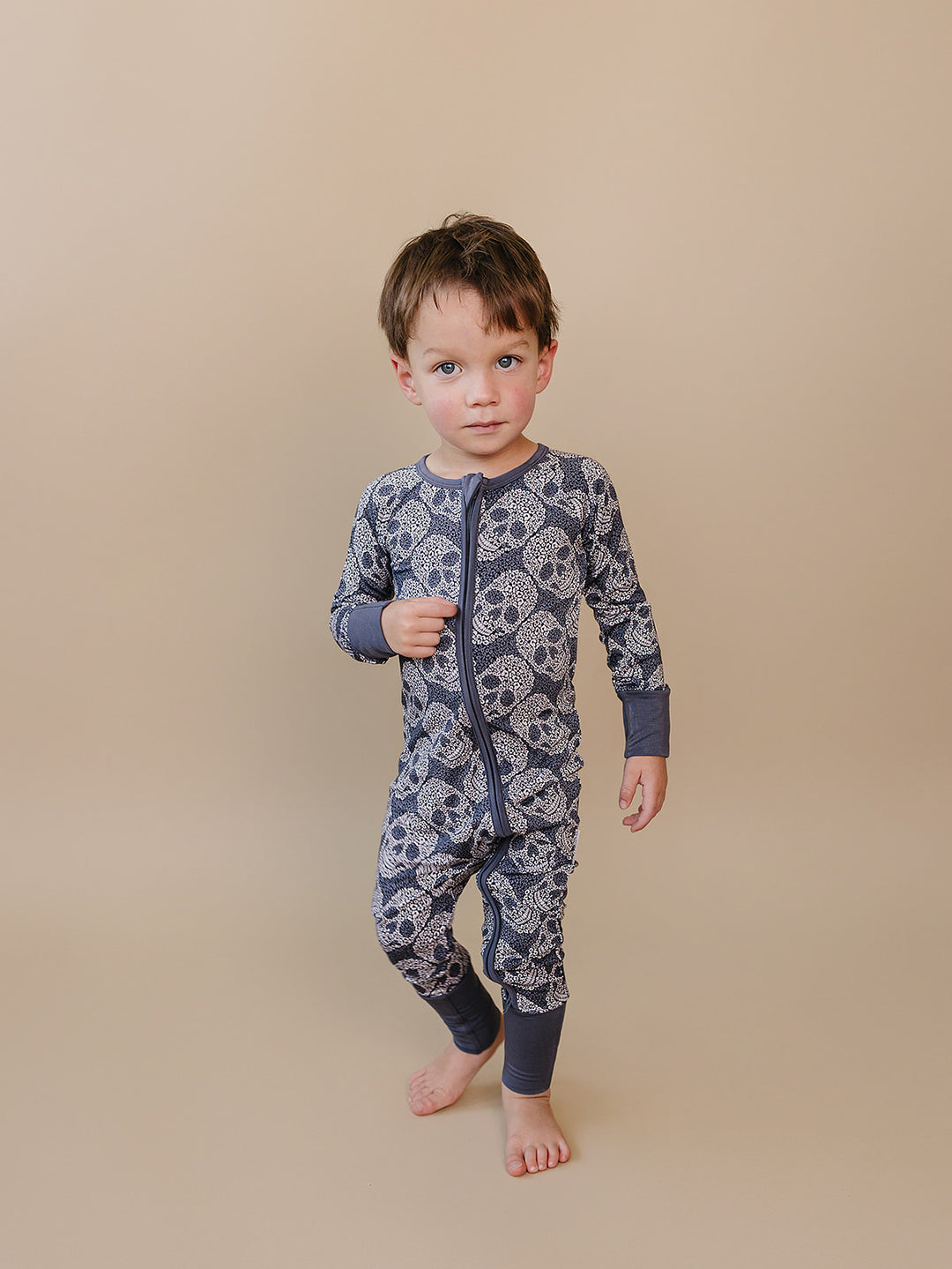 Front view of a toddler modeling the Leopard Skull Bamboo Zip Romper.