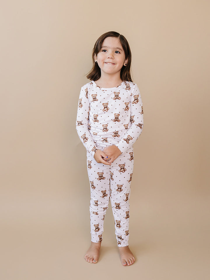 Older child modeling the white Cute Bear bamboo long-sleeve pajama set.