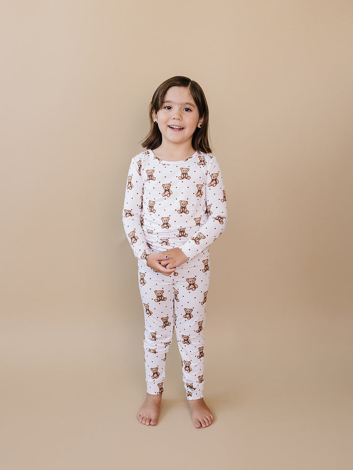 Child modeling the white teddy bear-print bamboo top and matching pants.