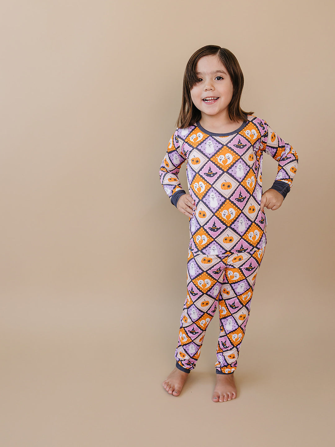 Girl modeling the purple, orange, and cream Ghost Whimsy Halloween Bamboo Two Piece Set.