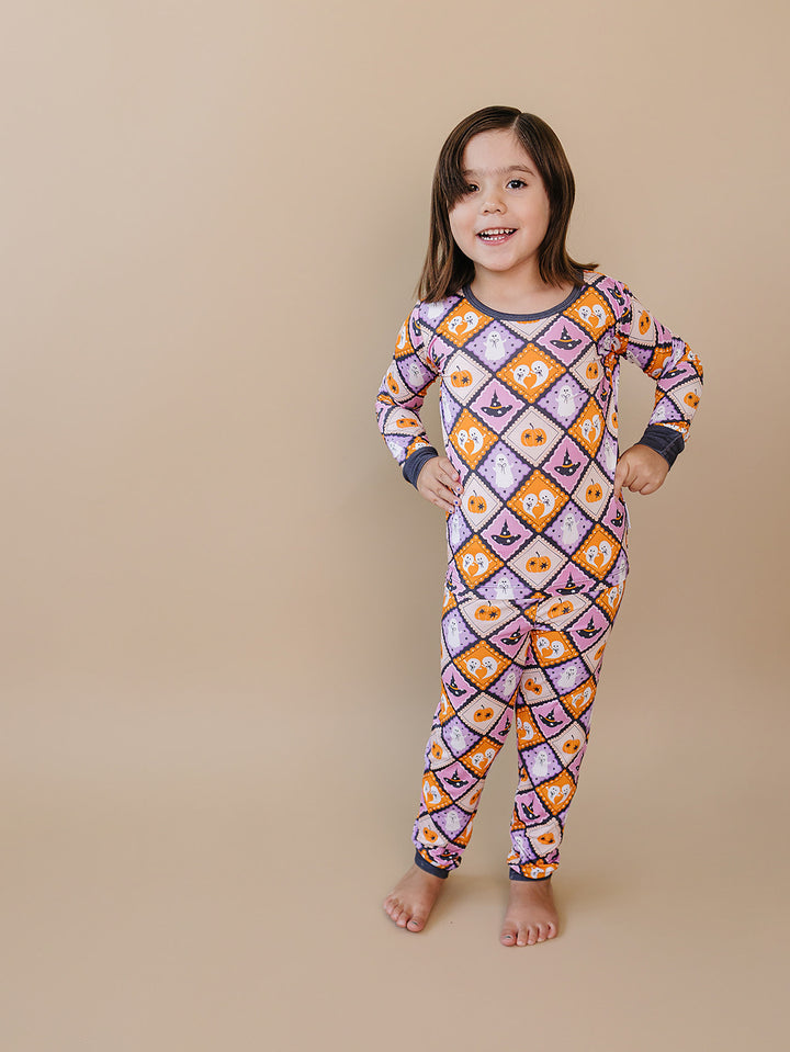 Girl modeling the purple, orange, and cream Ghost Whimsy Halloween Bamboo Two Piece Set.