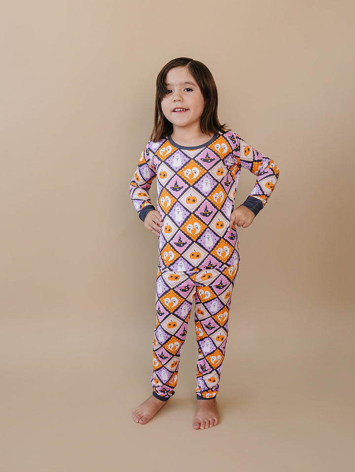 Girl posing with her hands on her hips in the Ghost Whimsy Halloween pajama set.