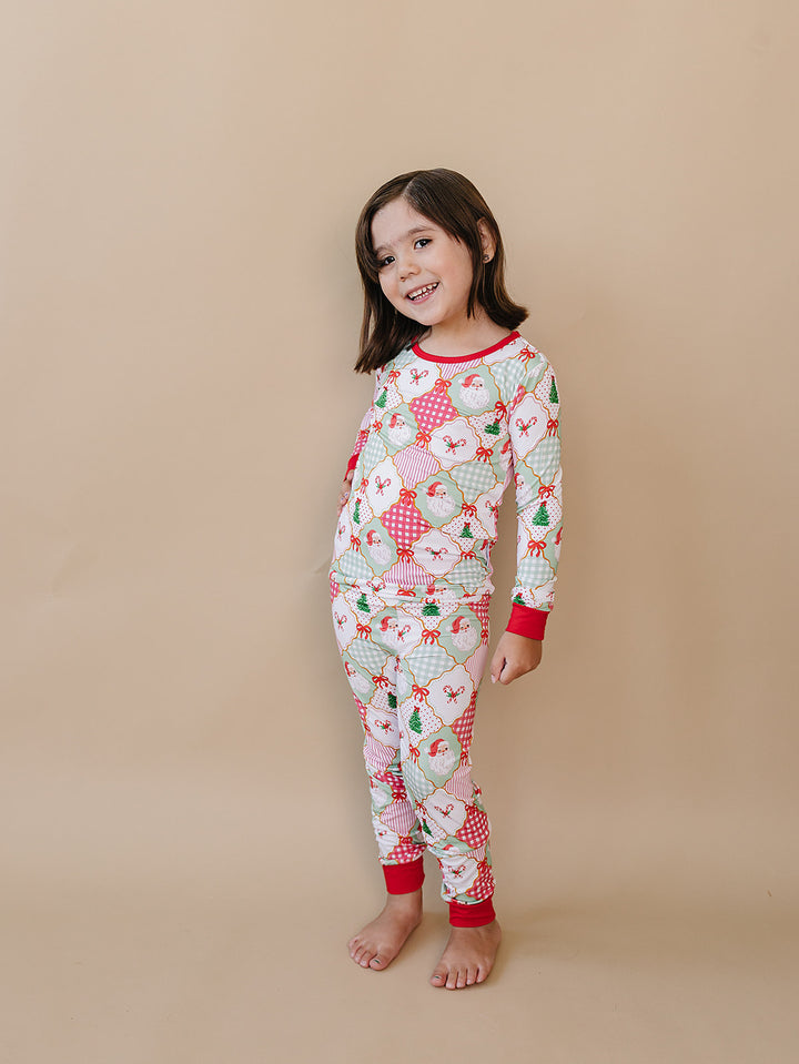 Santa Patchwork Bamboo Two Piece — toddler girl in ornament patchwork Christmas pajama set, Lucky Panda Kids
