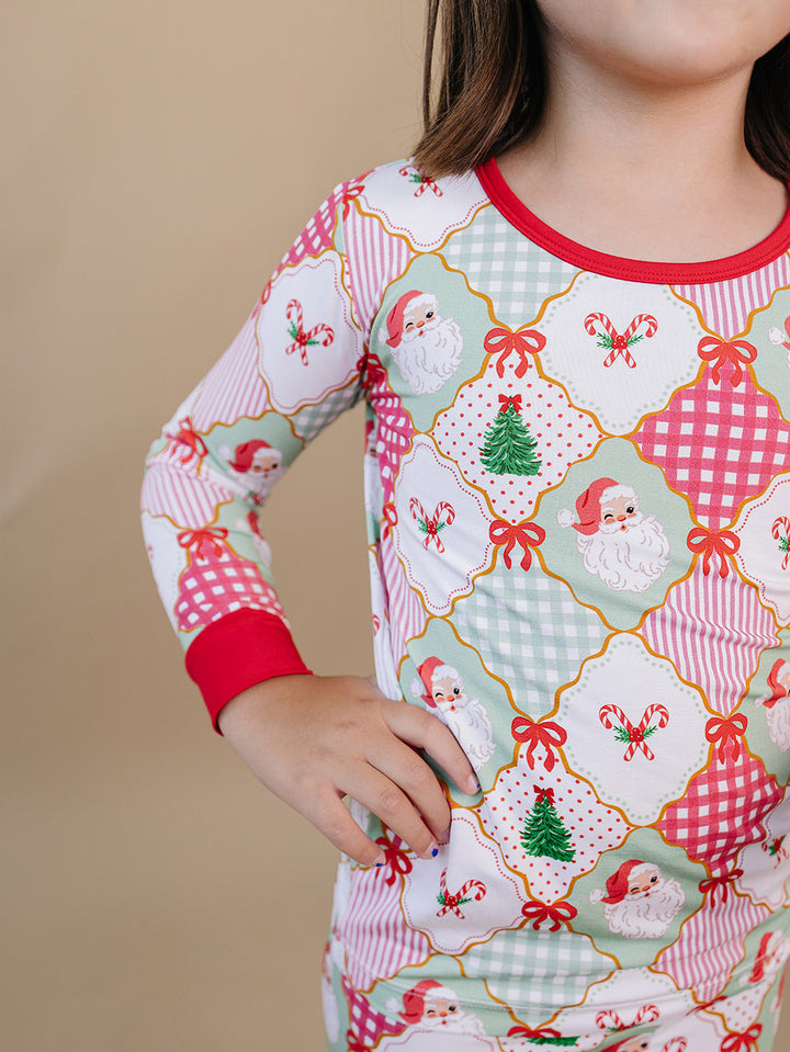 Santa Patchwork Bamboo Two Piece — toddler girl in ornament patchwork Christmas pajama set, Lucky Panda Kids
