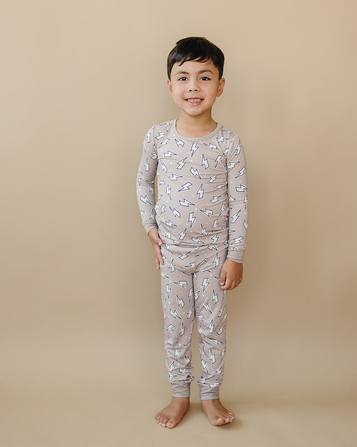 Child modeling the Latte Bolts bamboo two-piece set in a full-length front view.