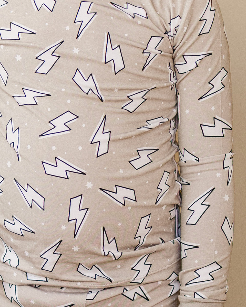 Close-up of the Lucky Panda Kids Latte Bolts bamboo two-piece set, showing the warm taupe lightning bolt print.