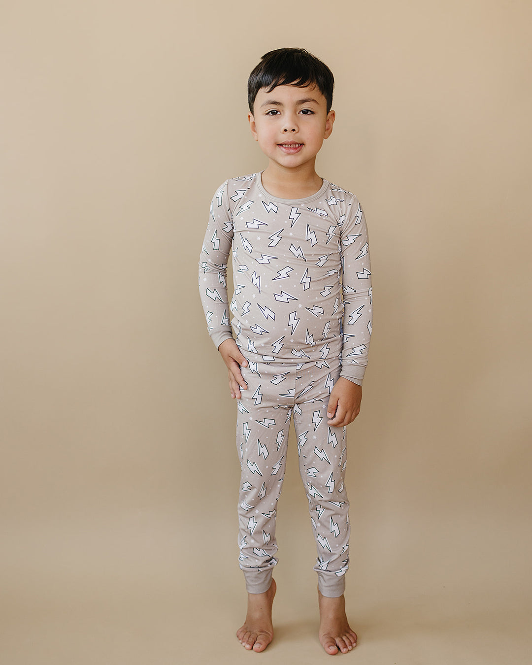 Child modeling the Latte Bolts bamboo two-piece set from the front, showing the long-sleeve top and matching pants.