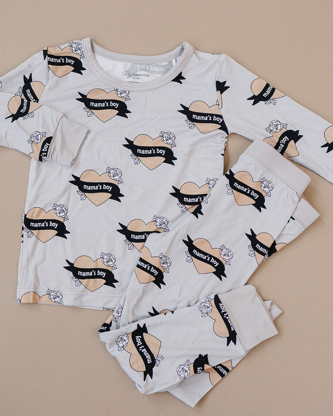 Mama’s Boy bamboo long-sleeve top and matching pants with heart-and-banner print displayed flat.