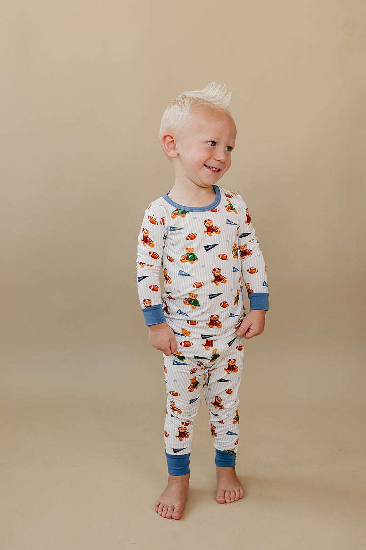 Child standing in the Touchdown Teddy bamboo top and matching pants.