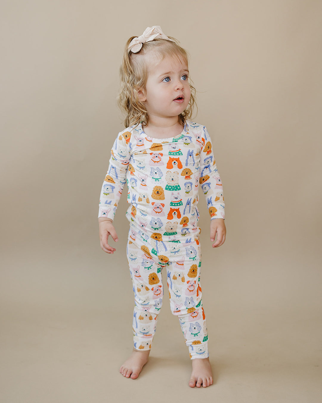 Toddler looking to the side while wearing the Puppy Club bamboo two-piece set.