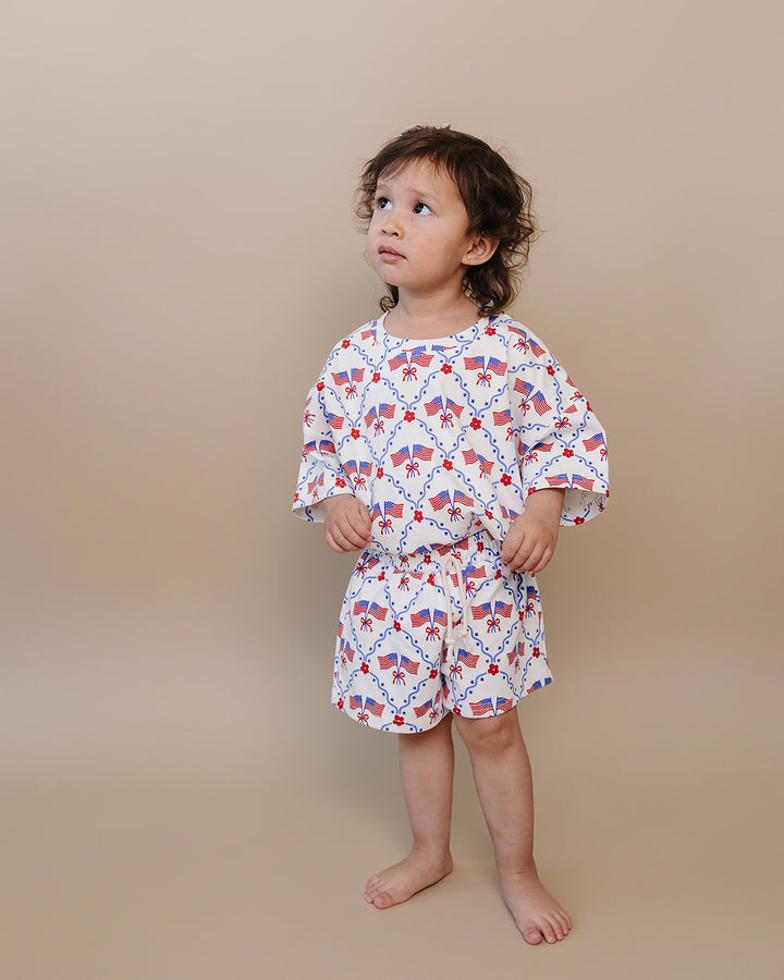 Toddler girl in Lucky Panda Kids 4th of July cotton shorts set, American Girl design — relaxed fit top with faux drawstring