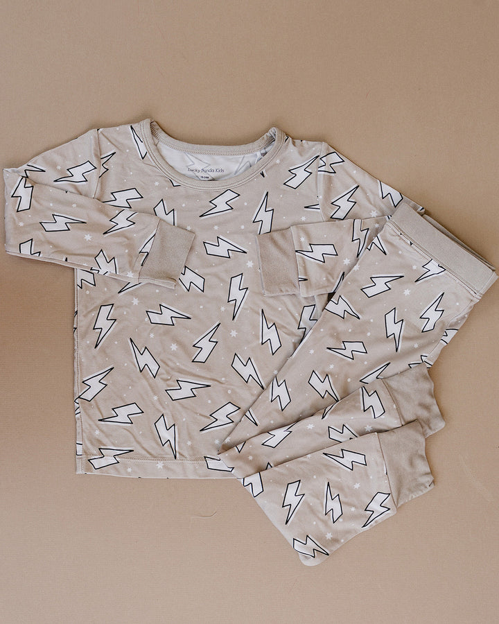 Latte Bolts bamboo long-sleeve top and matching pants laid flat, showing the complete lightning bolt print.