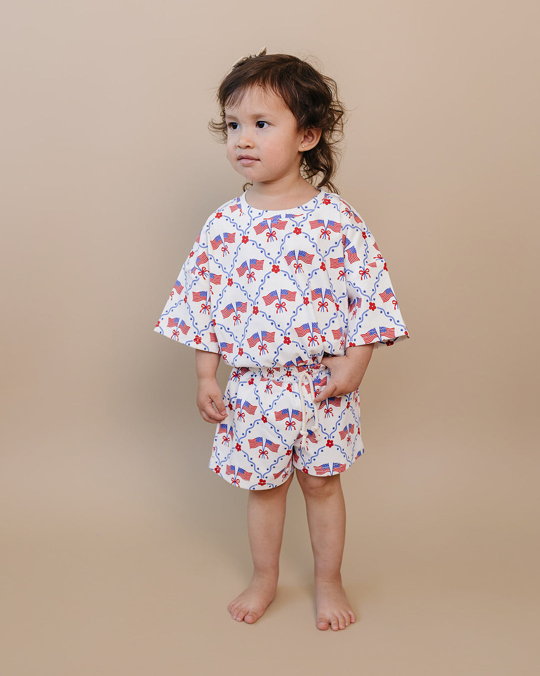 Toddler girl in Lucky Panda Kids 4th of July cotton shorts set, American Girl design — relaxed fit top with faux drawstring