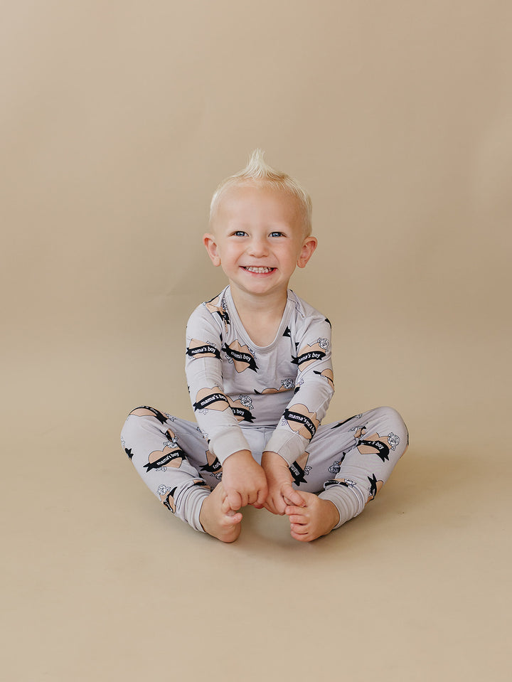 Toddler sitting cross-legged in the Mama’s Boy bamboo two-piece set.