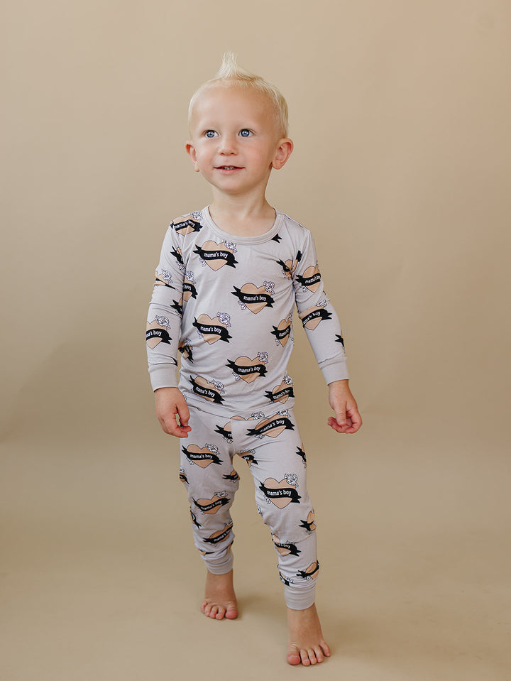 Toddler looking to the side while wearing the Mama’s Boy heart-print bamboo top and pants.