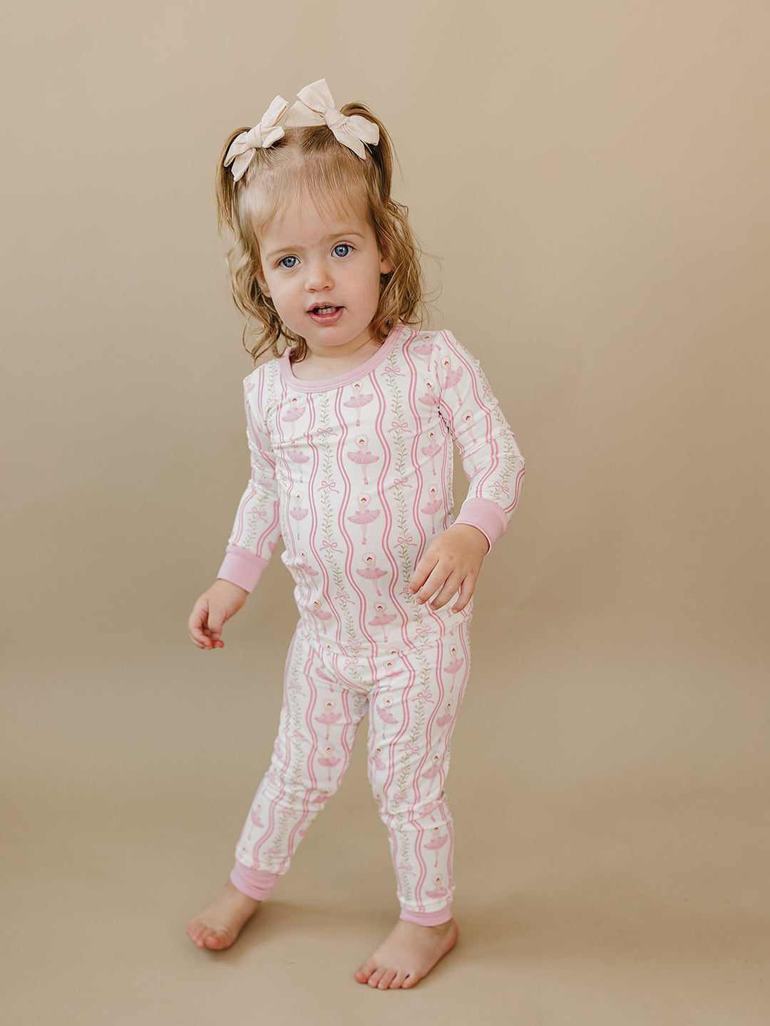 Toddler walking in the Little Ballerina bamboo two-piece set against a neutral background.