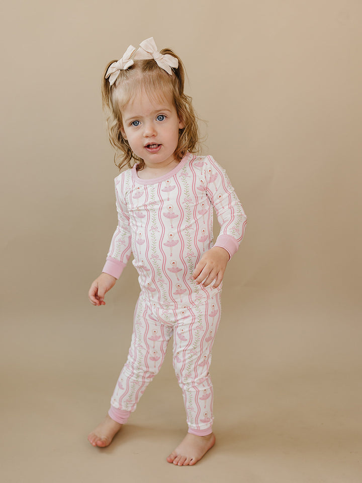 Toddler walking in the Little Ballerina bamboo two-piece set against a neutral background.
