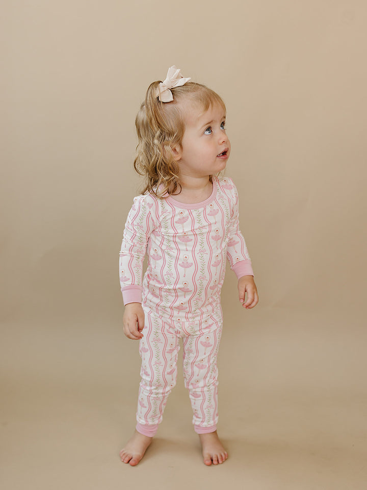 Toddler wearing the Little Ballerina ballerina-print bamboo top and matching pants.
