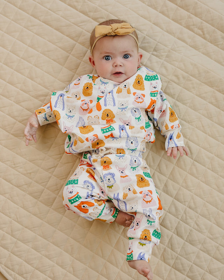 Puppy Club cotton top and matching joggers with colorful dog illustrations on a white background displayed flat.