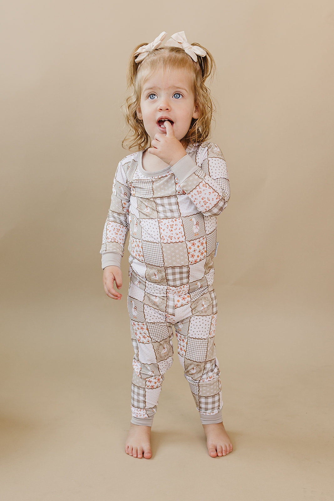 Smiling toddler walking forward in the Cottage Goose bamboo two-piece set.