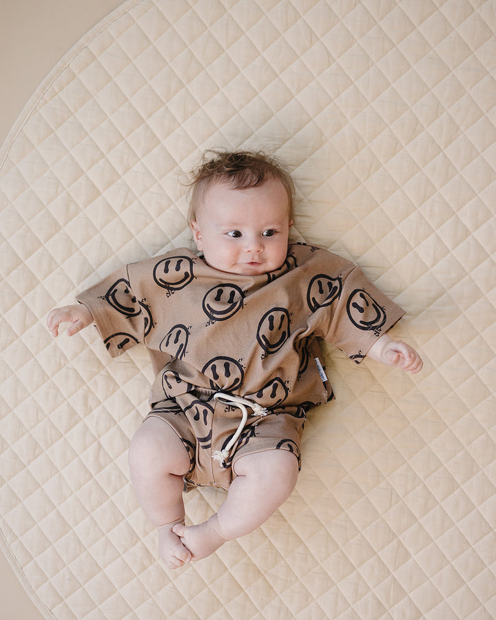 baby boy wearing Lucky Panda Kids Smiley Brown Shorts Set — warm brown all-over smiley face print cotton two-piece outfit