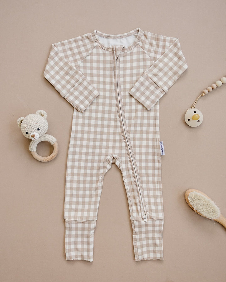 Lucky Panda Kids Beige Gingham bamboo zip romper displayed flat with neutral baby accessories.
