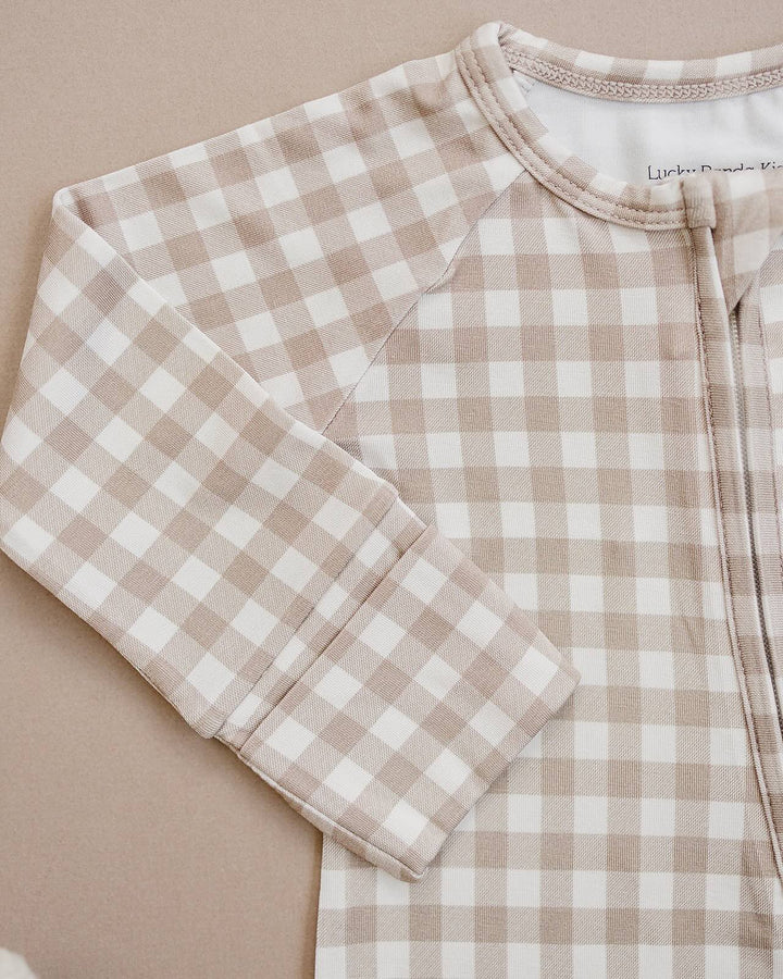 Close-up of the Beige Gingham bamboo romper, showing the neckline, zipper, and soft checkered fabric.