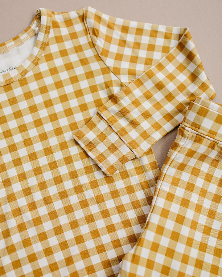 Close-up of the Yellow Gingham bamboo pajama top and pants, showing the neckline and checkered print.