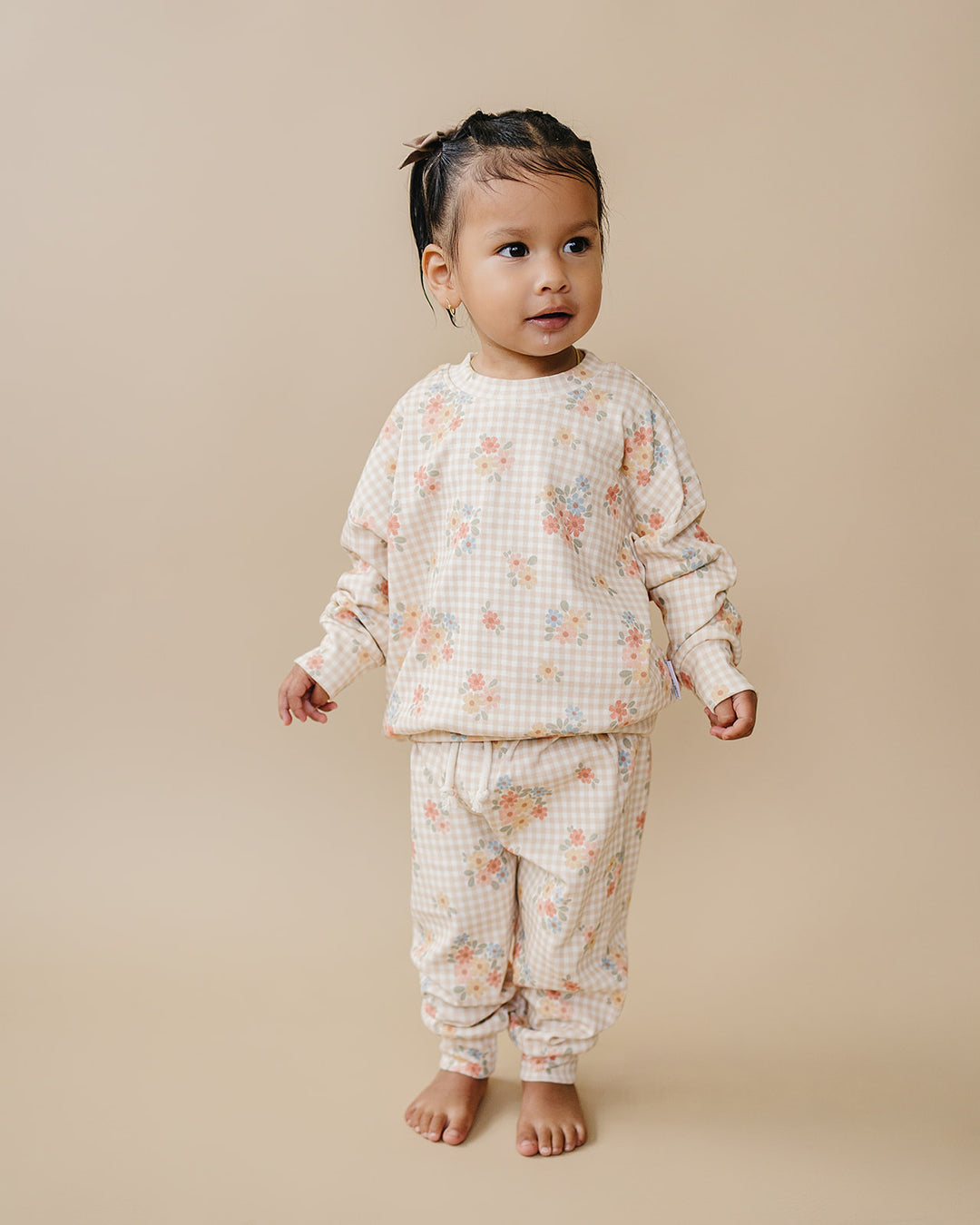 Toddler wearing the Lucky Panda Kids Wild Flower cotton jogger set against a neutral studio background.