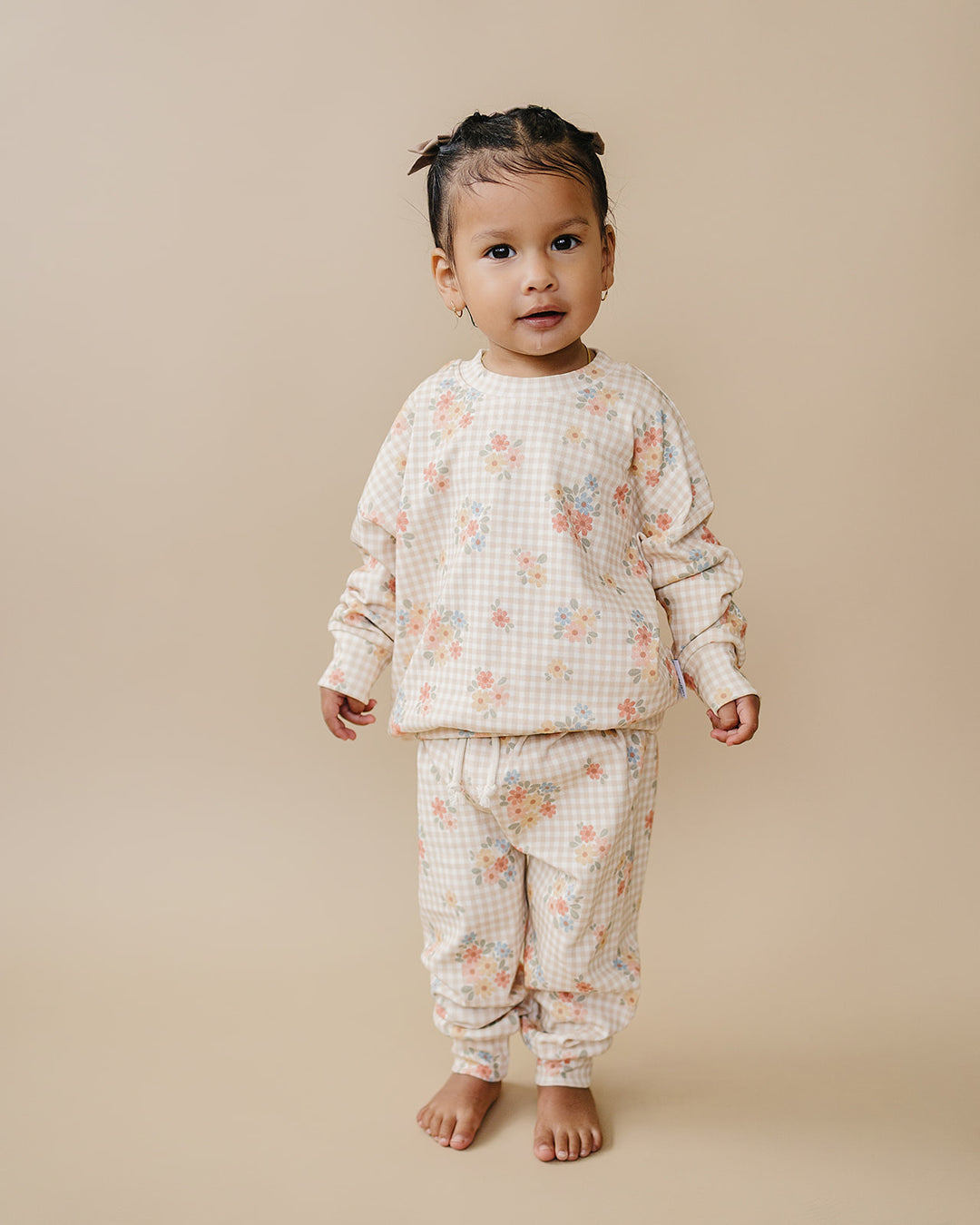 Toddler modeling the Lucky Panda Kids Wild Flower cotton jogger set in a full-length studio view.