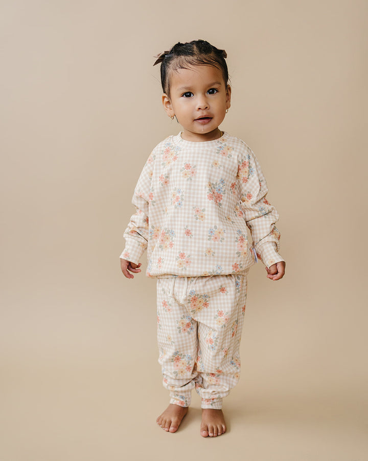 Toddler modeling the Lucky Panda Kids Wild Flower cotton jogger set in a full-length studio view.