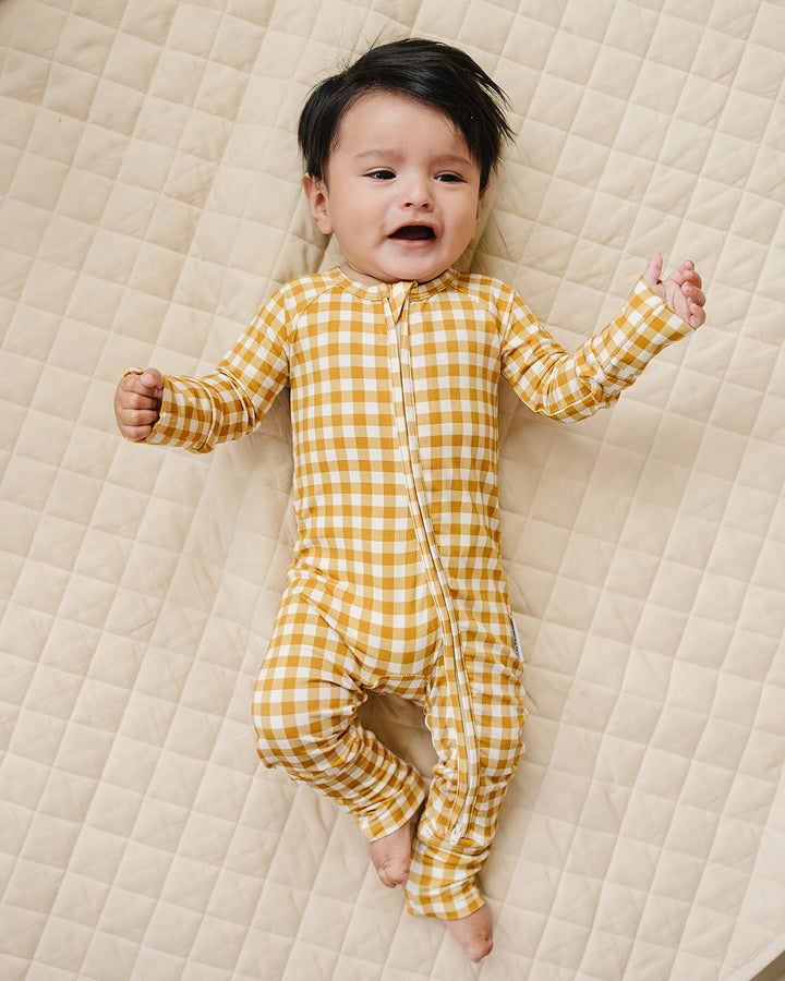Lucky Panda Kids Yellow Gingham bamboo zip romper displayed flat with neutral baby accessories.