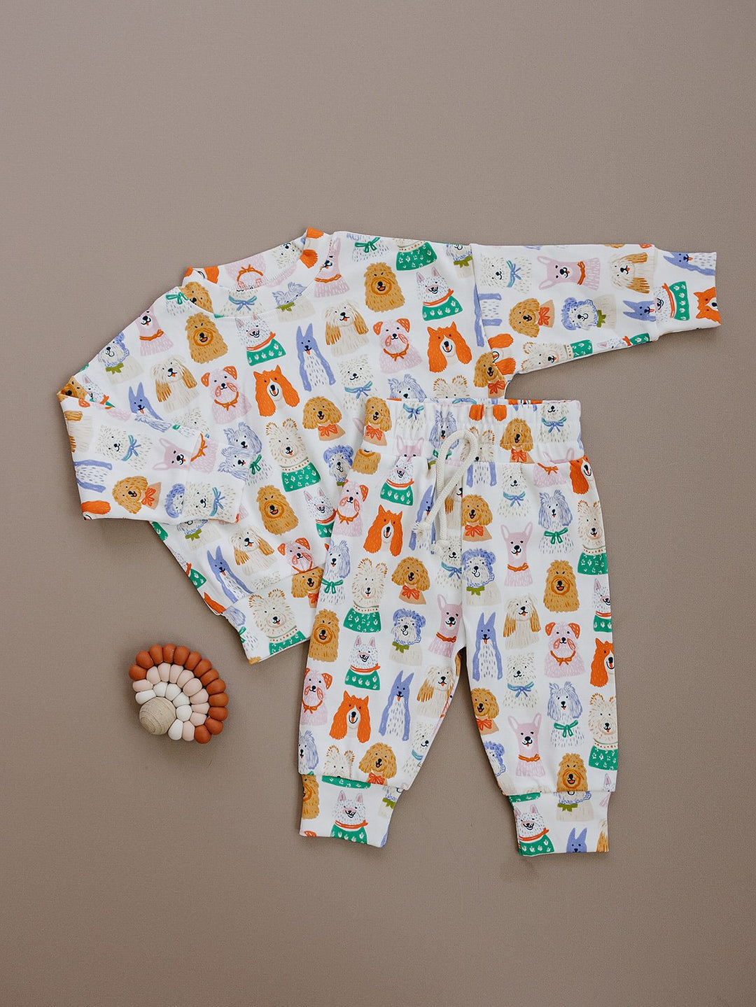 Puppy Club cotton top and matching joggers with colorful dog illustrations on a white background displayed flat.
