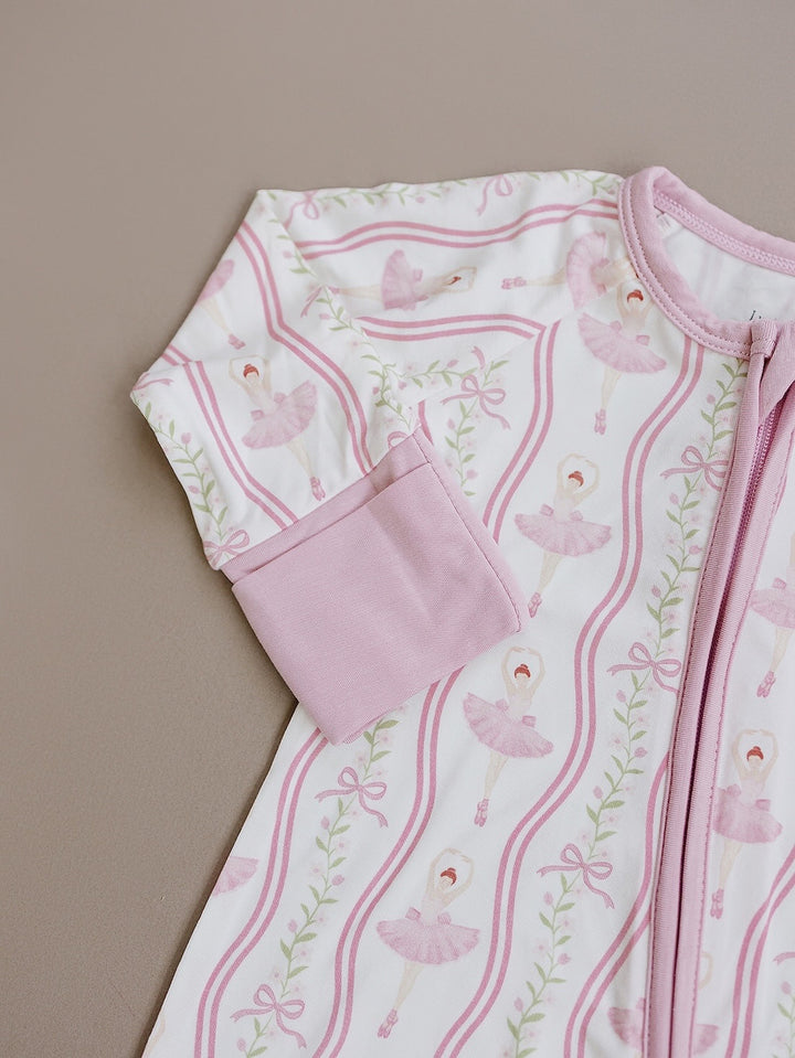 Close-up flat lay of the pink ballerina print and zipper on the Little Ballerina bamboo romper.