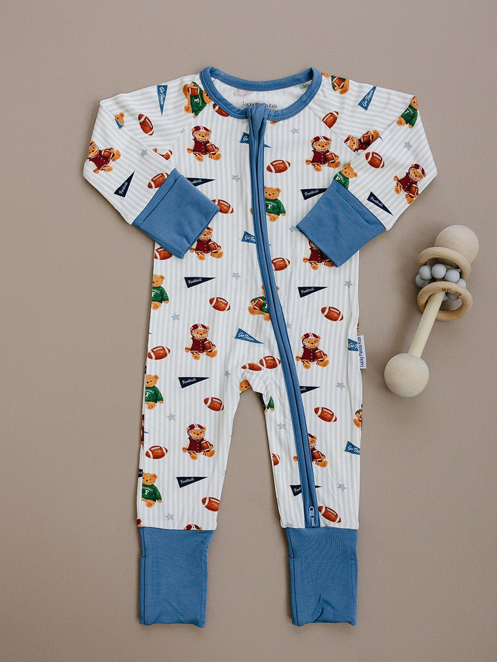 Touchdown Teddy bamboo zip romper with dusty blue trim displayed as a flat lay.