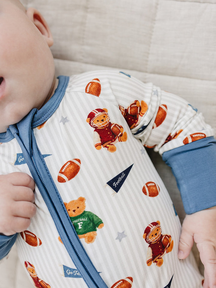 Close-up of the football and teddy bear print on the Touchdown Teddy zip romper.