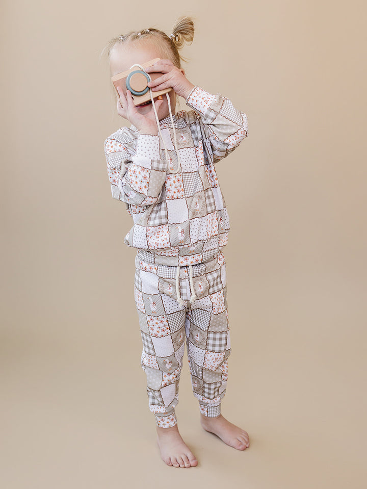 Toddler girl standing in the Cottage Goose jogger set, showing the relaxed fit and cuffed jogger pants.
