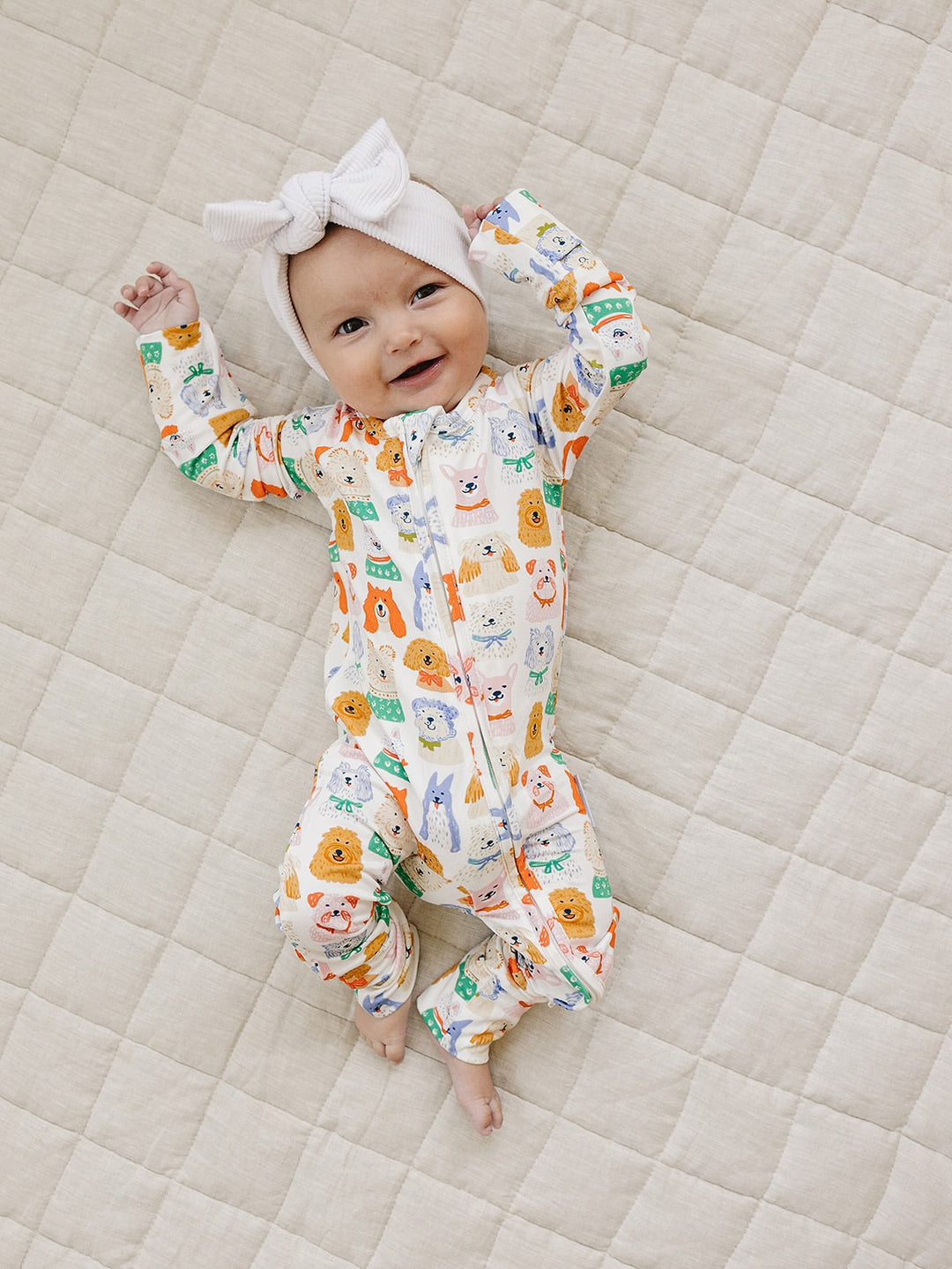 Toddler stepping forward in the Puppy Club bamboo long-sleeve top and matching pants with colorful puppy illustrations.