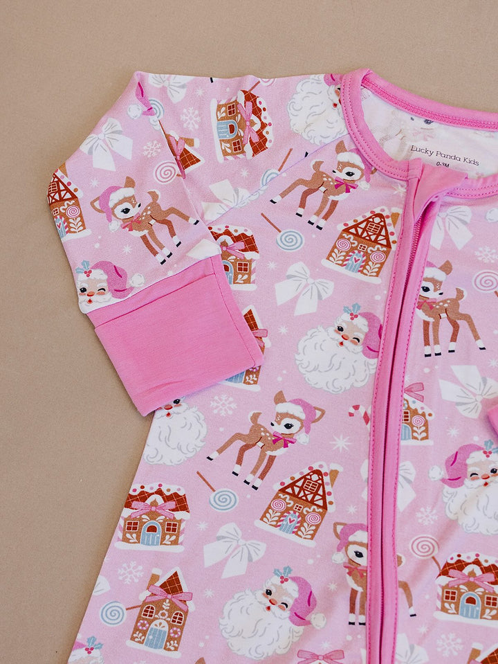 Detail of the Pink Christmas romper laid flat, showing the pink neckline, zipper and sleeve cuff.