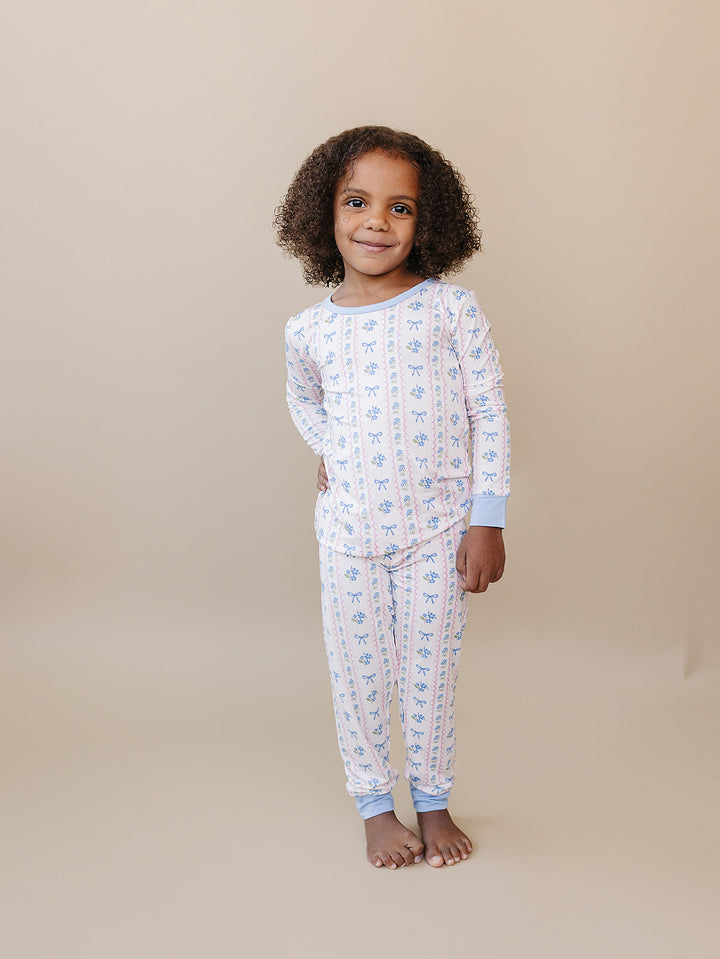 Full-length front view of a child wearing the Whimsy Bloom bamboo top and matching pants.