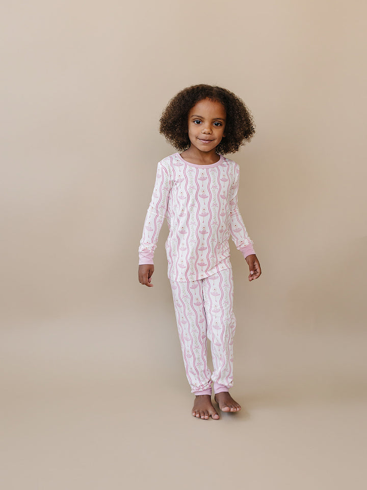 Child standing in the Little Ballerina long-sleeve bamboo top and matching pants.