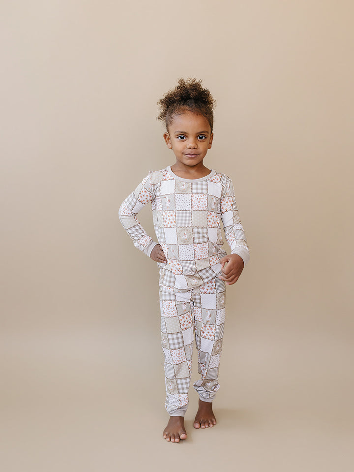 Child walking toward the camera in the Cottage Goose bamboo two-piece set, showing its relaxed fit.