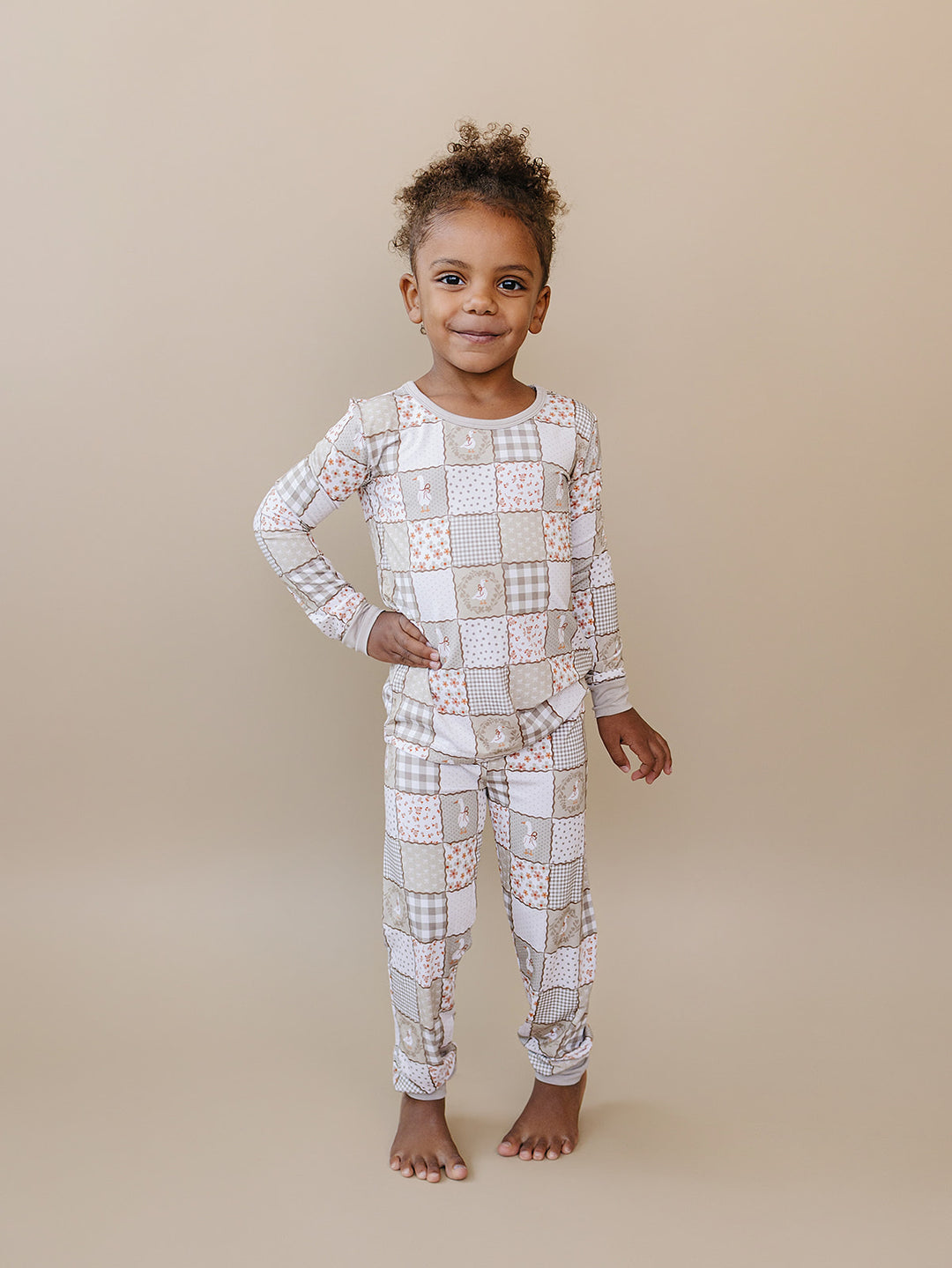Child modeling the Cottage Goose bamboo two-piece set in a full-length front studio view.