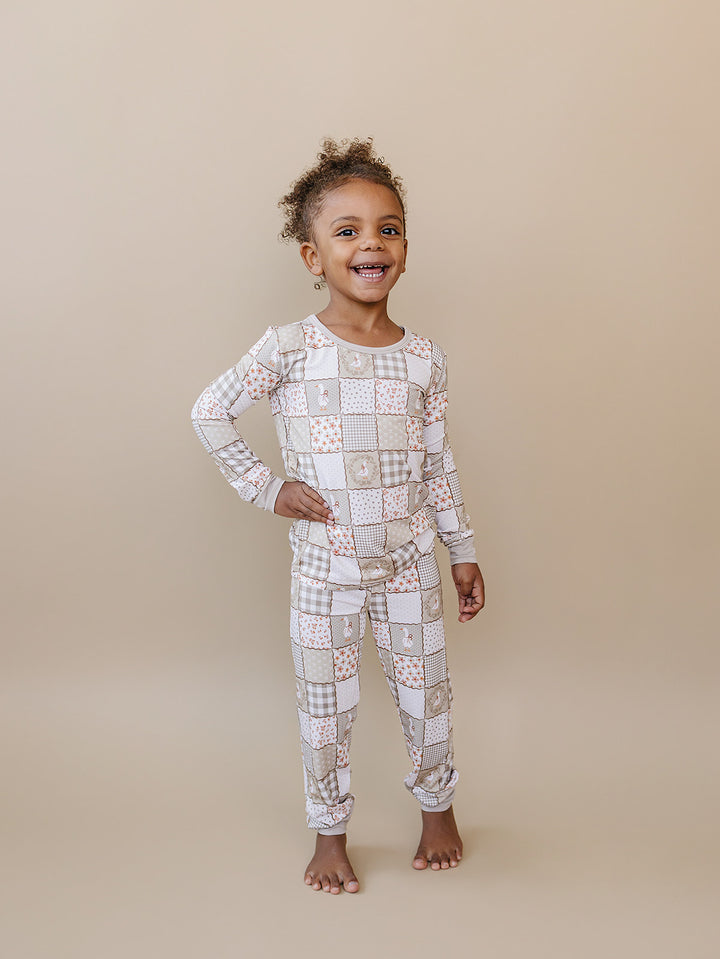 Child standing with one hand on her hip in the Cottage Goose bamboo two-piece set.