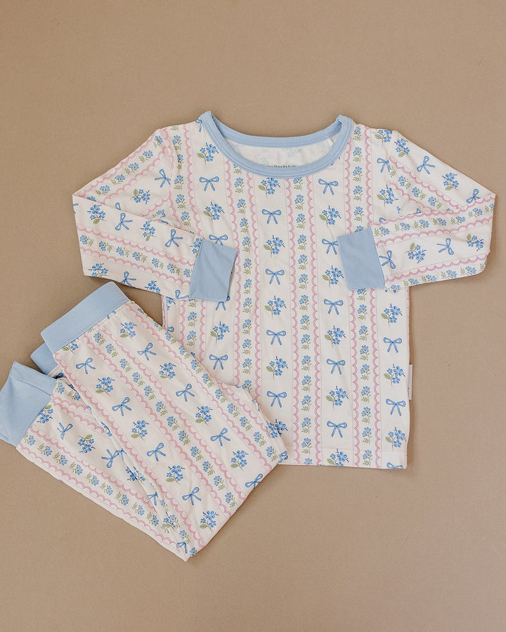 Whimsy Bloom bamboo long-sleeve top and matching pants with blue trim displayed flat.