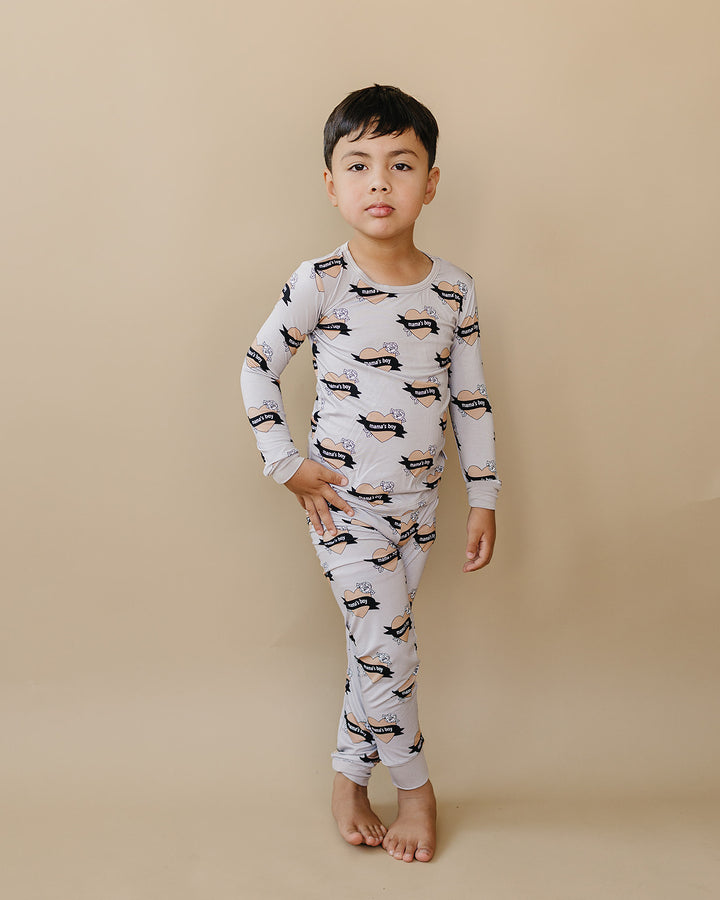 Child standing with one hand at their hip in the Mama’s Boy bamboo two-piece set.