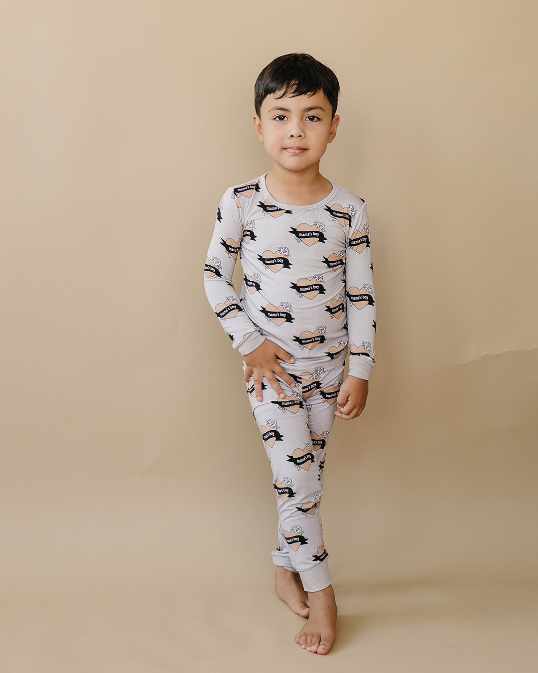 Full-length front view of a child wearing the Mama’s Boy bamboo top and matching pants.