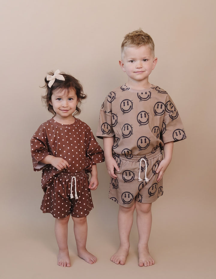 Toddler girl & boy wearing Lucky Panda Kids Brown Polka Shorts Set — brown and white polka dot cotton two-piece outfit