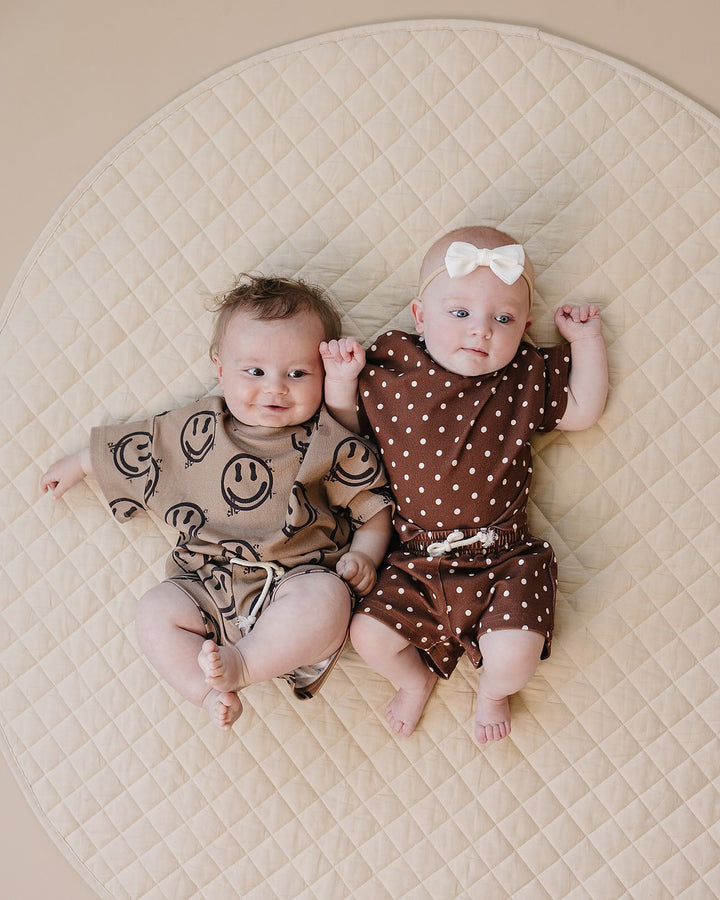 baby boy wearing Lucky Panda Kids Smiley Brown Shorts Set — warm brown all-over smiley face print cotton two-piece outfit
