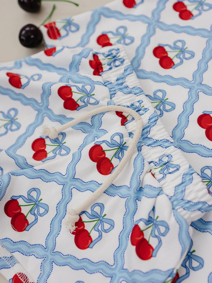 Lucky Panda Kids Sweet Cherry Cotton Shorts Set flat lay — top and shorts.Close-up of Sweet Cherry Cotton Shorts Set fabric showing cherry print and soft cotton texture